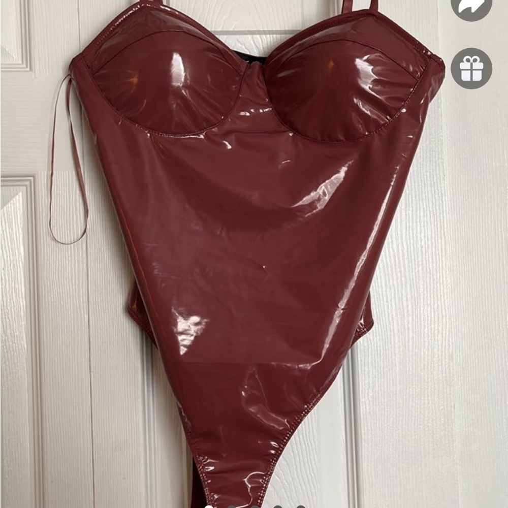 Cute pink latex-ish material body suit, says large but most likely fits a small